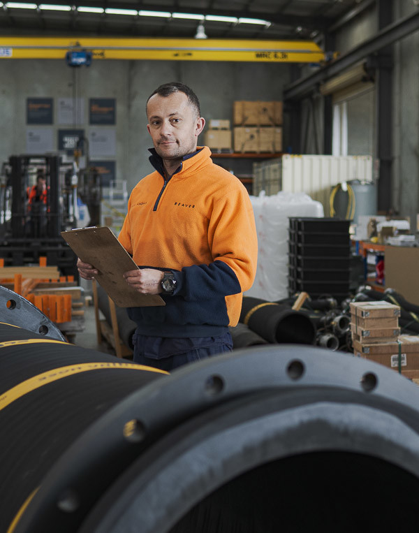 A BPE technician inspecting mining hose in our workshop