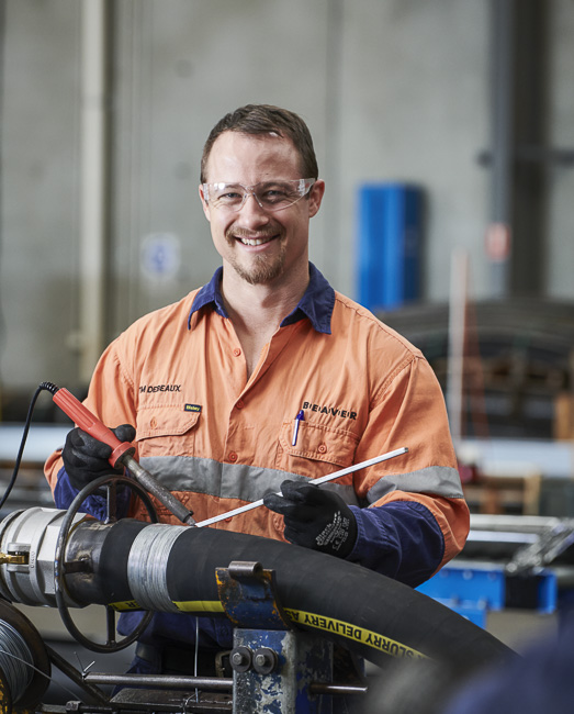 A team member fabricating a custom hose assembly