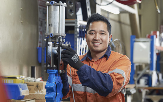 Valve technician working on a new valve automation job in the workshop