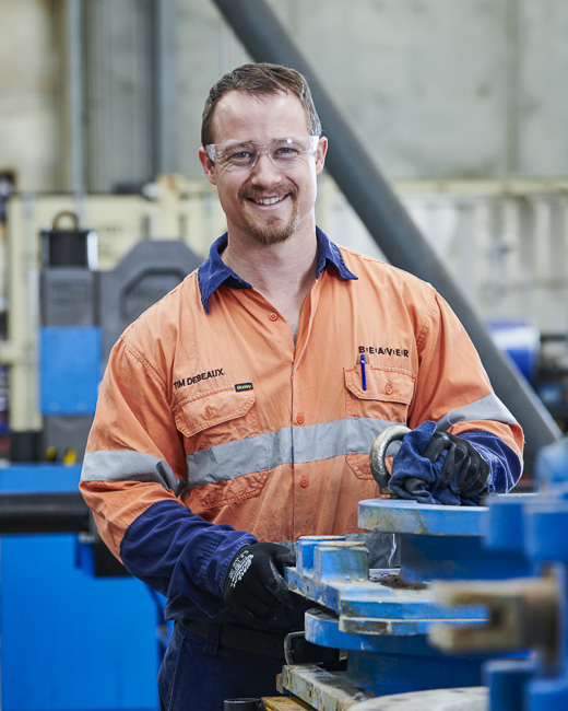 Valve technician repairing a large knife gate valve in our workshop