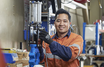 Valve technician working on a new valve automation job in the workshop