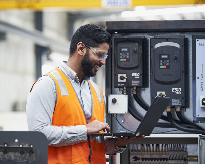 An engineer inspecting custom made control panels