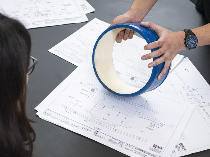 Water pipelines image, holding a piece of DICL pipe