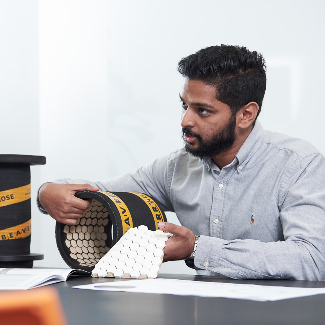 An engineer demonstrating CLX ceramic lined hose