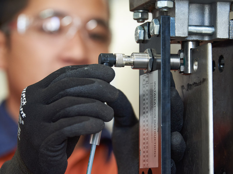 An industrial specialist installing valve actuation controls in our Australian manufacturers facility in Perth