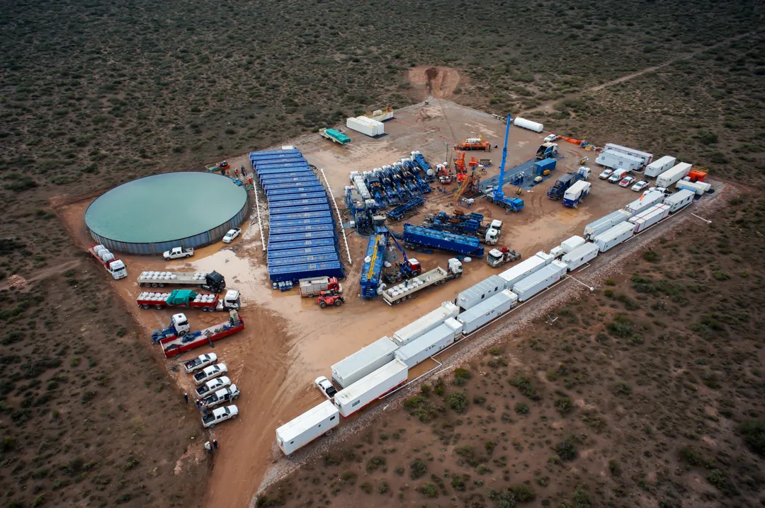 Aerial view of a fracking operation site with truck-mounted equipment