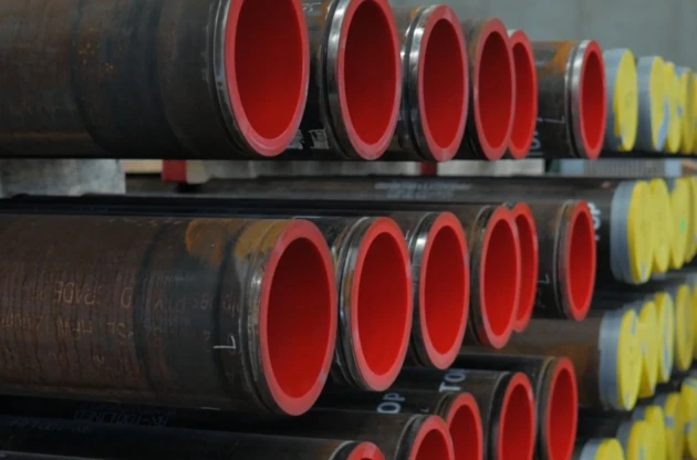 Stacked polyurethane-lined slurry pipe spools showing the wear liner inside
