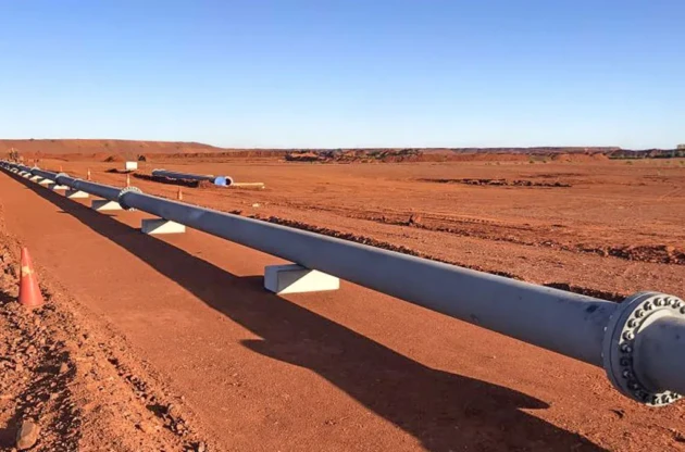 Installed slurry pipeline running across a Pilbara mine site